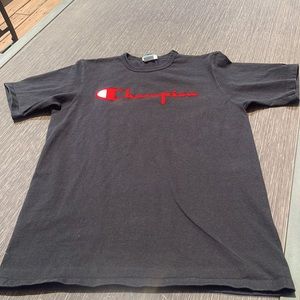 Men’s black Champion tshirt with classic red felt. Size LG